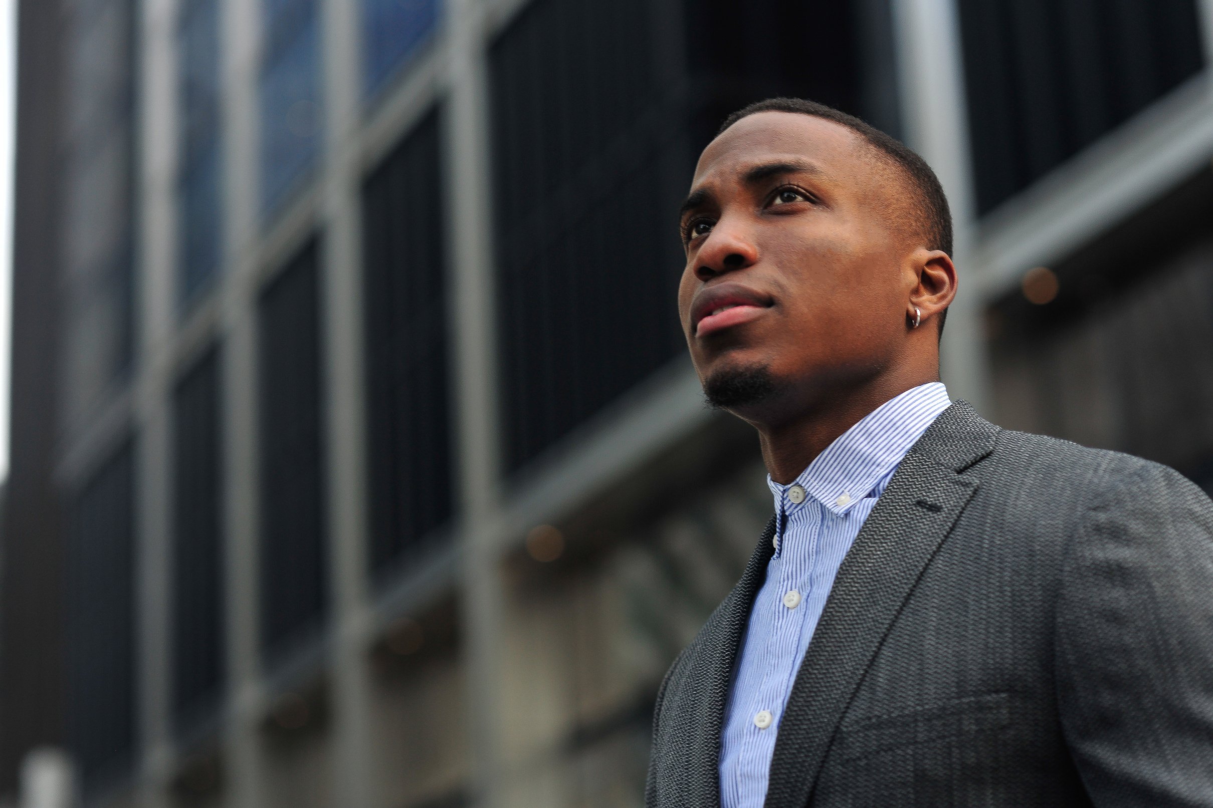 Young Black Male Professional Looking Forward Standing near Buil