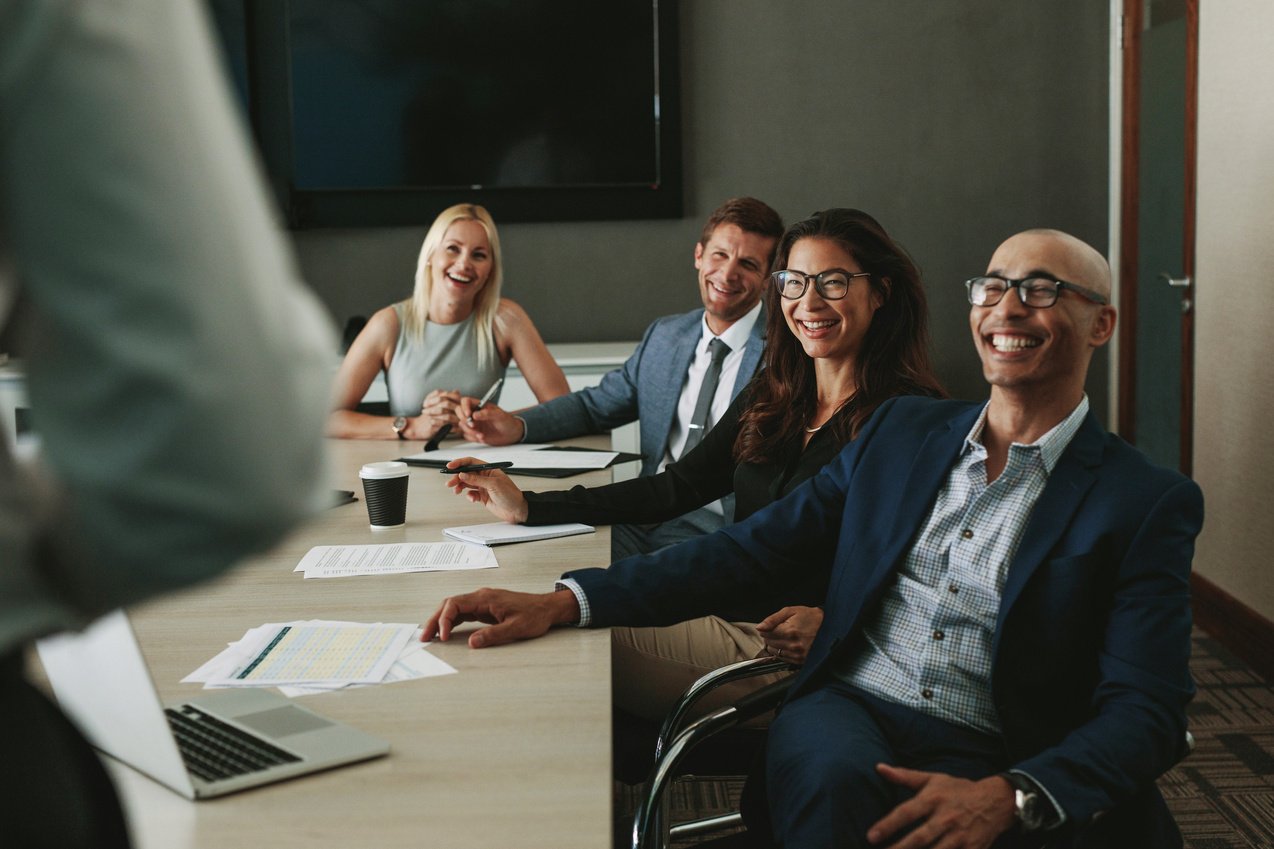 Business People Smiling during Meeting in Board Room